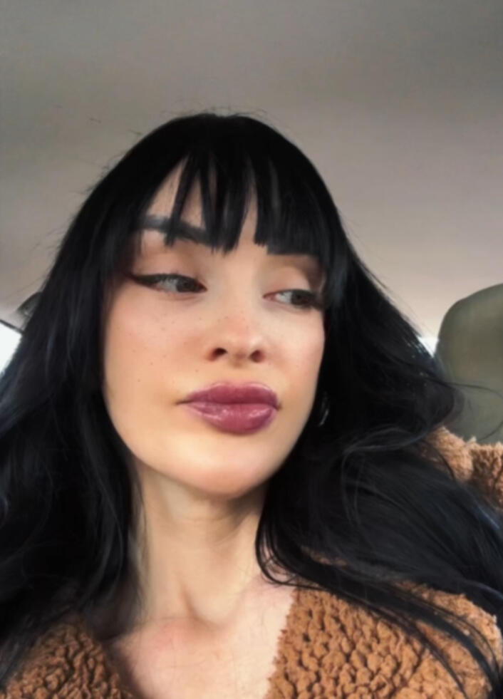 Jessica Muñoz cis-gender white woman's face, with long black hair and bangs